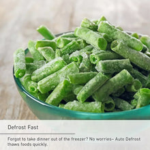 Frozen green vegetable pieces in bowl with “Defrost Fast” label