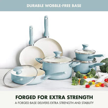 Light blue cookware set with multiple pans and glass lids