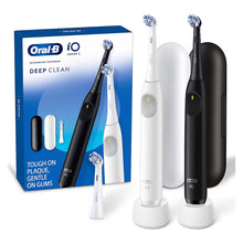 Electric toothbrush set: white and black powered handles with brush heads.