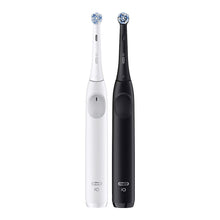 Pair of rechargeable electric toothbrush handles, one white and one black.