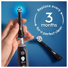 Toothbrush handle with blue bristle head and additional replacement heads