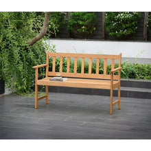 Outdoor wooden patio bench with slatted back and seat, armrests, light finish.