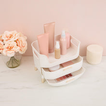 White beauty organizer with open drawers and top compartment, holding bottles and tubes