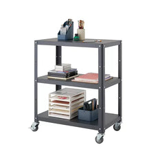 Dark grey utility cart with three shelves holding office supplies on casters