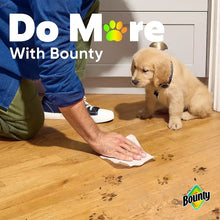 Bounty paper towels sheet being used on a wooden floor from the pack