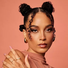 Model with defined curls, hands near face and neck