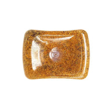 Seasoning bottle close-up with orange-brown granules