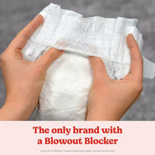 White diaper held in hands, printed with lion and rainbow graphics