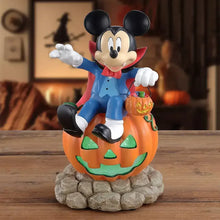Mickey Mouse vampire light-up figure holding pumpkin bucket on rocky base