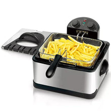 Stainless steel deep fryer with fries in wire basket and black lid and control knobs
