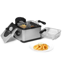 Stainless steel electric deep fryer with fries in basket and cooked rings on a plate