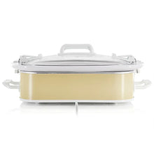 Cream slow cooker with clear glass lid and chrome rim, white handles