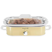 Cream slow cooker with clear lid, filled with cooked food inside