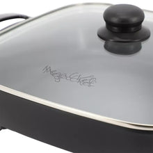 Glass lid with black knob on an electric skillet; MegaChef logo on lid
