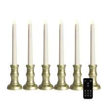 Set of six ivory LED window candles with gold-tone bases and a black remote control