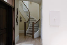 White in-wall add-on toggle switch mounted on wall, Enbrighten