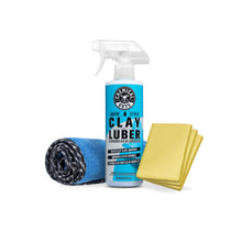 Clay lube spray bottle with rolled blue microfiber towel and yellow clay bar blocks