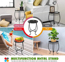 Black metal plant stand with round top, curved legs, and decorative scroll feet.