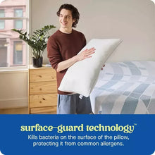 White pillow held by a person indoors