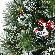 Flocked evergreen branches with warm lights and red berry ornaments