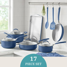 Blue ceramic cookware set with multiple pots, utensils, and baking rack