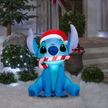 Inflatable Stitch figure in Santa hat, blue body with red-and-white hat and striped scarf