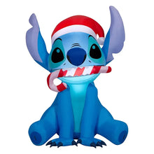 Inflatable Stitch figure facing forward, blue body with Santa hat and red-striped scarf