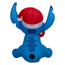 Inflatable Stitch figure from behind, blue body with red Santa hat and white trim