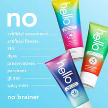 Children's fluoride toothpaste tubes, blue and pink with green tube partially visible