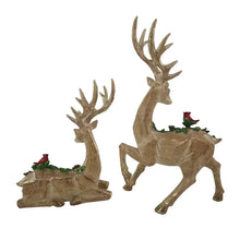 Set of 2 golden deer figurines: one standing, one seated, both with greenery and berries