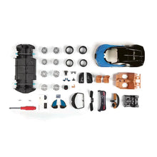 Model kit parts laid out: wheels, body panels, small accessories, and clear windows