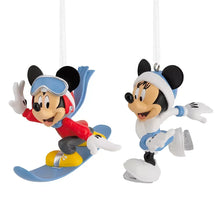 Two character ornament figures: one snowboarding, one ice skating, with hanging loops