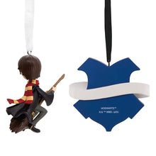 Set of 2 Hogwarts-themed ornaments: boy figure and crest with blue shield, on ribbons