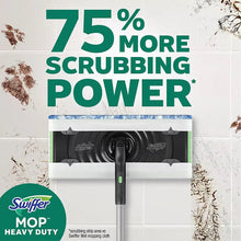 Swiffer heavy-duty mop with scrubbing head and cleaning pad over tile
