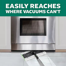 Swiffer mop with cleaning pad on floor for under-appliance cleaning