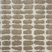 Texture close-up of taupe and ivory area rug with repeating arch pattern