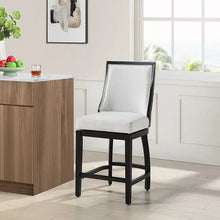 Upholstered barstool with light seat and back, dark wood legs and crossbar footrest