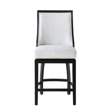 Counter barstool with light upholstered seat, dark frame, and arched footrest bar