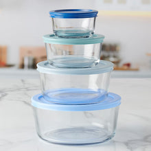 Stacked clear food storage containers with blue lid and white base, rounded rectangular