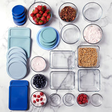 Assorted food storage containers with blue and light teal lids, square and round sizes