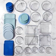 Food storage container set with light blue, teal, and blue lids; clear bases