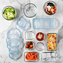 Assorted clear food storage containers with blue lids and small square containers