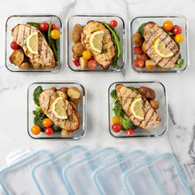 Clear rectangular food storage containers with blue snap lids filled with meals