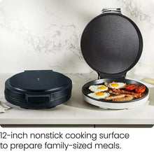 Pizza oven with lid open over a nonstick cooking plate, showing eggs and toppings
