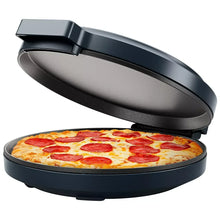 Pizza oven with lid open over a round pizza with red and green toppings