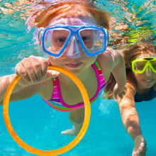Child swimming and holding an orange sparkly pool dive ring