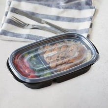 Clear-lidded black meal prep container with food inside and sealed lid