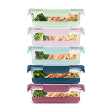Glass meal prep containers filled with vegetables and food, with colored snap lids