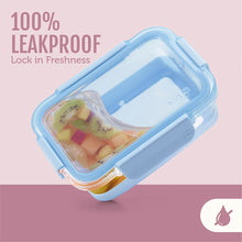 Blue glass food storage container with translucent lid, fruit pieces inside