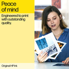Printed photo sheets with blue artwork held by a woman